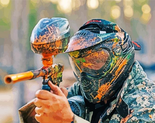 A man in camouflage gear holding a paintball gun.